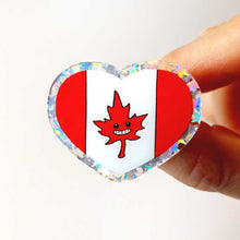 Load image into Gallery viewer, heart acrylic pin featuring the Canada flag, the maple leaf stylized with happy face.
