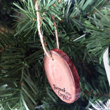 Load image into Gallery viewer, side/back view of wood ornament hanging on a christmas tree, painted to look like a pepperoni pizza
