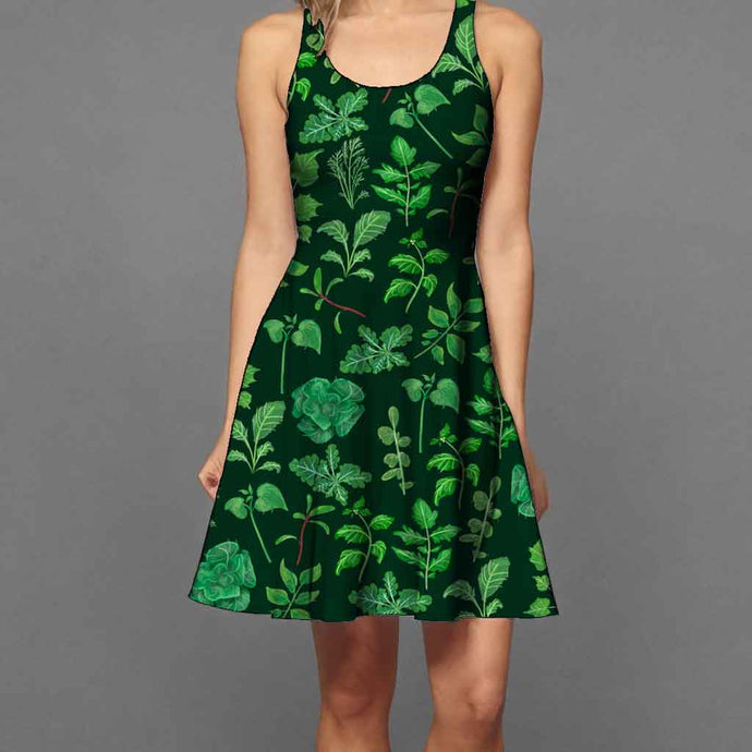 a woman wearing the Plant Lovers Green Dress, a skater style dress featuring an all over print, illustrated with a variety of plants from the garden