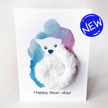 Load image into Gallery viewer, a greeting card with an illustration of a polar bear. thick, fluffy white yarn makes up the bear&#39;s body. the background has a splash of blue and purple. the front says, &quot;Happy Bear-day!&quot;
