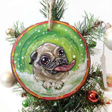 Load image into Gallery viewer, a wood ornament, hand painted with a pug in the snow, tongue out, ready to catch snowflakes

