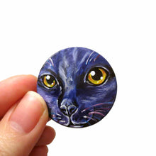 Load image into Gallery viewer, A wood disc painted with the portrait of a cat in dark purple and black
