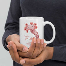Load image into Gallery viewer, hands holding a white ceramic mug, 11 oz size, with an illustration of a smiling axolotl next to the text &quot;Time to.. Relaxalotl&quot;
