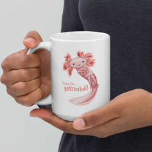 Load image into Gallery viewer, hands holding a white ceramic mug, 15 oz size, with an illustration of a smiling axolotl next to the text &quot;Time to.. Relaxalotl&quot;
