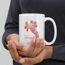Load image into Gallery viewer, hands holding a white ceramic mug, 15 oz size, with an illustration of a smiling axolotl next to the text &quot;Time to.. Relaxalotl&quot;

