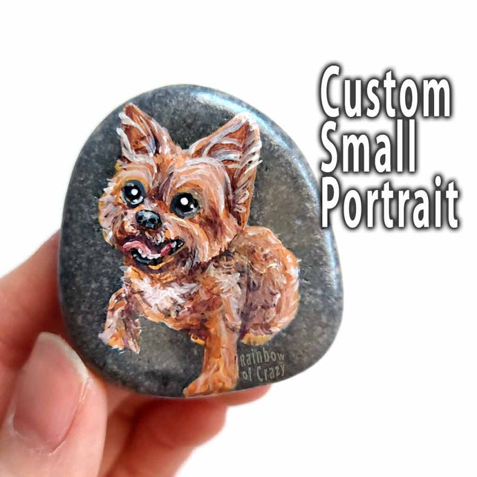 hand painted stone, featuring a smiling yorkshire terrier. 