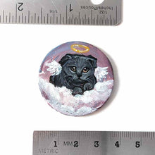 Load image into Gallery viewer, a small wood circle, hand painted with the portrait of a dark gray scottish fold cat, as an angel, with halo and wings, sitting on clouds against a pink and purple sky. available as a wood keepsake or pendant necklace
