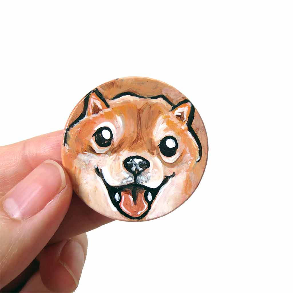 small wood disc painted with a smiling Shiba inu's face. available as a keepsake or pendant necklace 