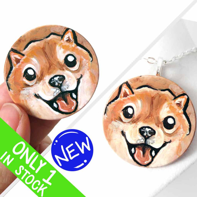 small wood disc painted with a smiling Shiba inu's face. available as a keepsake or pendant necklace 