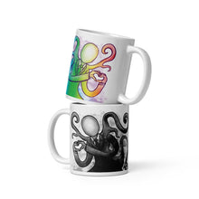 Load image into Gallery viewer, The 11 oz Slender Man Love mug: white ceramic mug with an illustration of Slender Man forming a heart with his hands, in all the colours of the rainbow. below that a second mug, showing it from the other side, featuring the same illustration, mirrored, in black and white.
