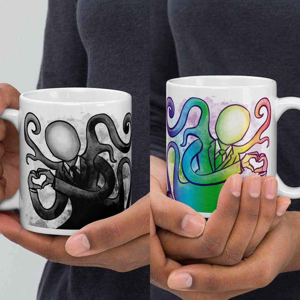 one hand holding a 11 oz white ceramic mug with an illustration of Slender Man forming a heart with his hands. a second hand is holding a second mug, showing it from the other side, featuring the same illustration, mirrored, in all the colours of the rainbow.
