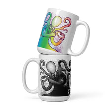 Load image into Gallery viewer, The 15 oz Slender Man Love mug: white ceramic mug with an illustration of Slender Man forming a heart with his hands, in all the colours of the rainbow. below that a second mug, showing it from the other side, featuring the same illustration, mirrored, in black and white.
