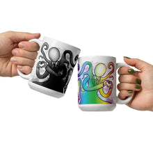 Load image into Gallery viewer, one hand holding a 15 oz white ceramic mug with an illustration of Slender Man forming a heart with his hands. a second hand is holding a second mug, showing it from the other side, featuring the same illustration, mirrored, in all the colours of the rainbow.
