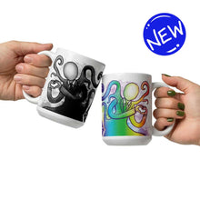 Load image into Gallery viewer, one hand holding a 15 oz white ceramic mug with an illustration of Slender Man forming a heart with his hands. a second hand is holding a second mug, showing it from the other side, featuring the same illustration, mirrored, in all the colours of the rainbow.
