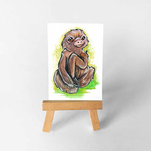 Load image into Gallery viewer, an aceo sized painting of a cute sloth against a green background. the painting sits on a wooden easel
