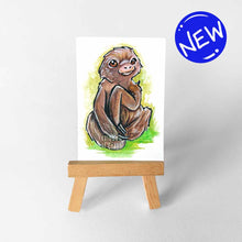 Load image into Gallery viewer, an aceo sized painting of a cute sloth against a green background. the painting sits on a wooden easel
