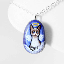 Load image into Gallery viewer, a small beach stone hand painted with the portrait of a snowshoe cat, as an angel on the clouds. available as a keepsake or pendant necklace
