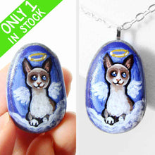 Load image into Gallery viewer, a small beach stone hand painted with the portrait of a snowshoe cat, as an angel on the clouds. available as a keepsake or pendant necklace
