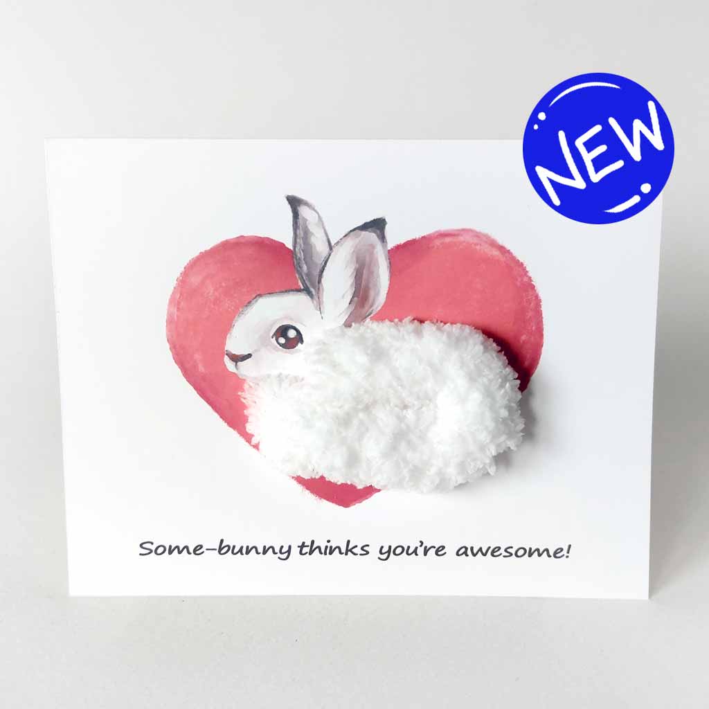 a greeting card with illustration of a snowshoe on front of a giant heart, its body made with fluffy white yarn. the card reads, 