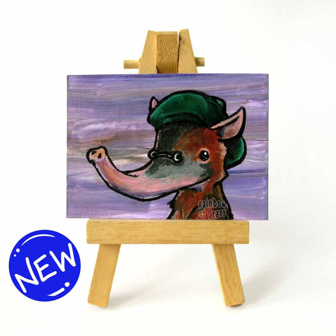 aceo sized painting of a solenodon wearing a green beret and tiny sunglasses agains ta soft purple background. painting sits on a tiny wood easel