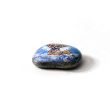 Load image into Gallery viewer, a beach stone, hand painted with a portrait of a sphynx cat, painted as an angel with halo and wings, sitting on fluffy clouds
