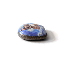 Load image into Gallery viewer, a beach stone, hand painted with a portrait of a sphynx cat, painted as an angel with halo and wings, sitting on fluffy clouds
