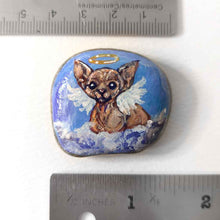 Load image into Gallery viewer, a beach stone, hand painted with a portrait of a sphynx cat, painted as an angel with halo and wings, sitting on fluffy clouds
