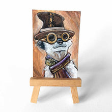Load image into Gallery viewer, an aceo sized painting, original art. portrait of a meerkat, wearing a steampunk outfit, complete with goggles, top hat, and scarf. 
