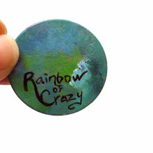 Load image into Gallery viewer, a small wood disc, hand painted with the portrait of a gray tabby cat, as an angel with wings and halo, sitting on clouds against a blue sky. this painting is available as a keepsake or pendant necklace. the back is signed with rainbowofcrazy
