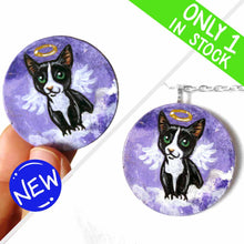 Load image into Gallery viewer, a portrait of a tuxedo cat as an angel, sitting on clouds against a purple sky, painted on a small wood disc, available as a keepsake or pendant necklace
