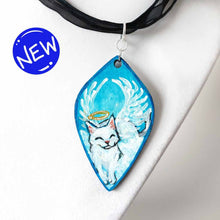 Load image into Gallery viewer, diamond shaped wood pendant necklace, hand painted with a smiling white cat as an angel, eyes closed, with a halo and wings, lying on clouds against a blue sky
