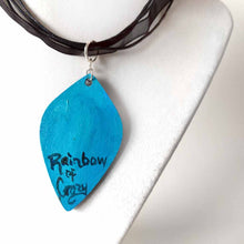 Load image into Gallery viewer, back of the white cat pendant, signed with Rainbow of Crazy
