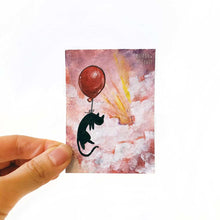 Load image into Gallery viewer, A hand holding an original ACEO painting of a black cat with a red balloon, floating  through the clouds in the sky, painted with reds and purples.
