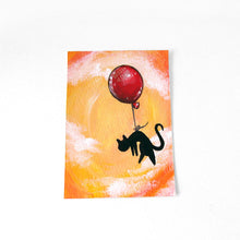 Load image into Gallery viewer, A small ACEO size painting of a black cat hanging from a red balloon, floating through a cloudy orange sky.
