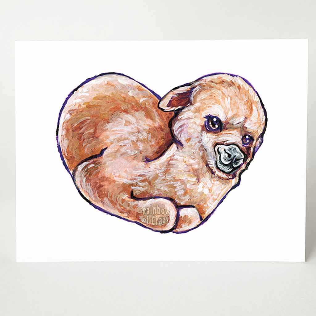 A greeting card with art of a brown alpaca on the front, curled up on the shape of a heart.