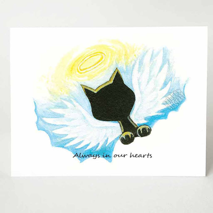 A greeting card with a black cat angel on the front, that reads, 