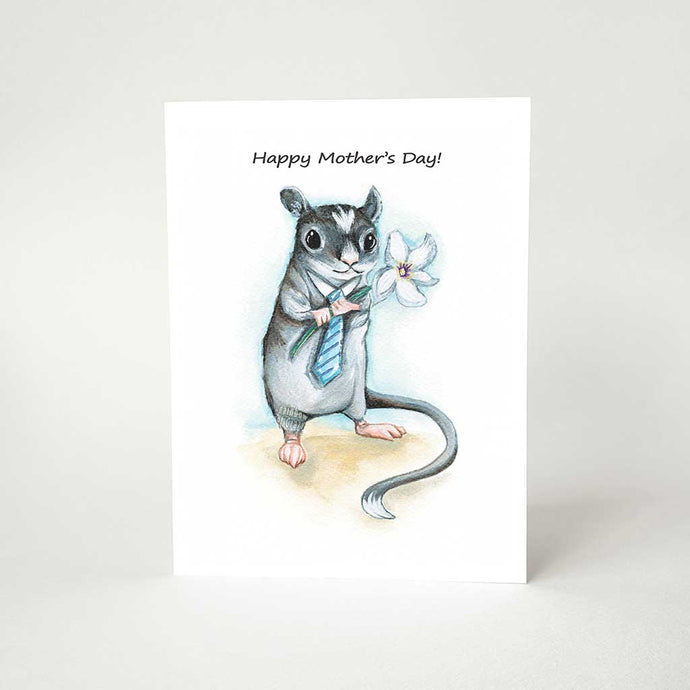 A greeting card printed wtih art of a gerbil, wearing a blue tie and holding a flower, it reads, 