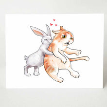 Load image into Gallery viewer, a greeting card with an illustration of a white rabbit giving a giant hug to a surprised orange cat
