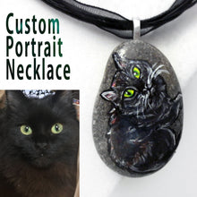 Load image into Gallery viewer, a small beach rock crafted into a custom portrait necklace, with art of a black cat with yellow and green eyes
