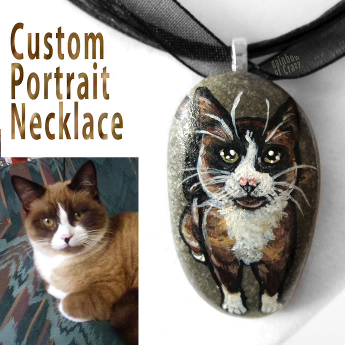 A personalized pet necklace, made from a beach stone, includes a portrait painting of a snowshoe cat