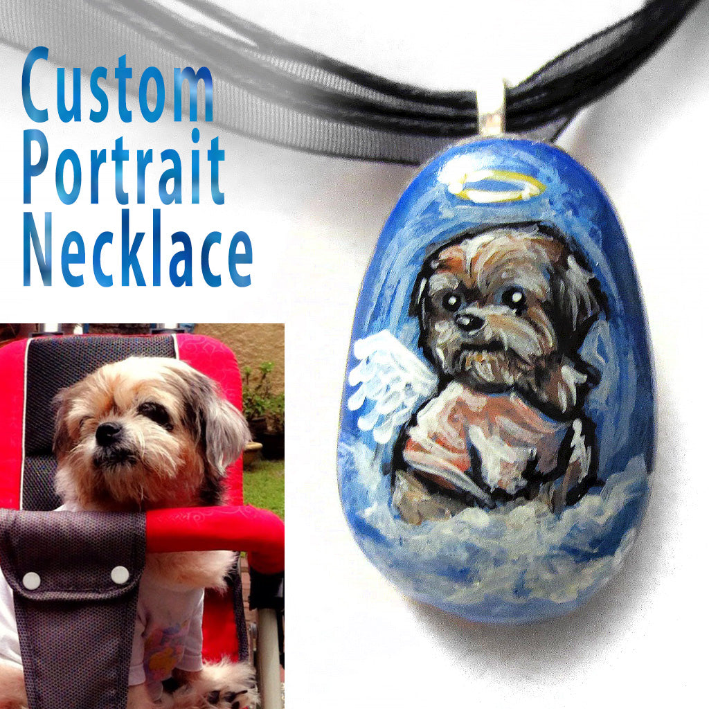 a custom pet portrait, painted on a small beach stone, of a brown dog as an angel and handmade into a neckalce