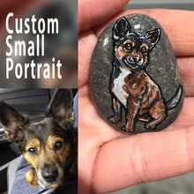 Load image into Gallery viewer, a small stone, custom painted with a pet portrait of a black and brown dog.
