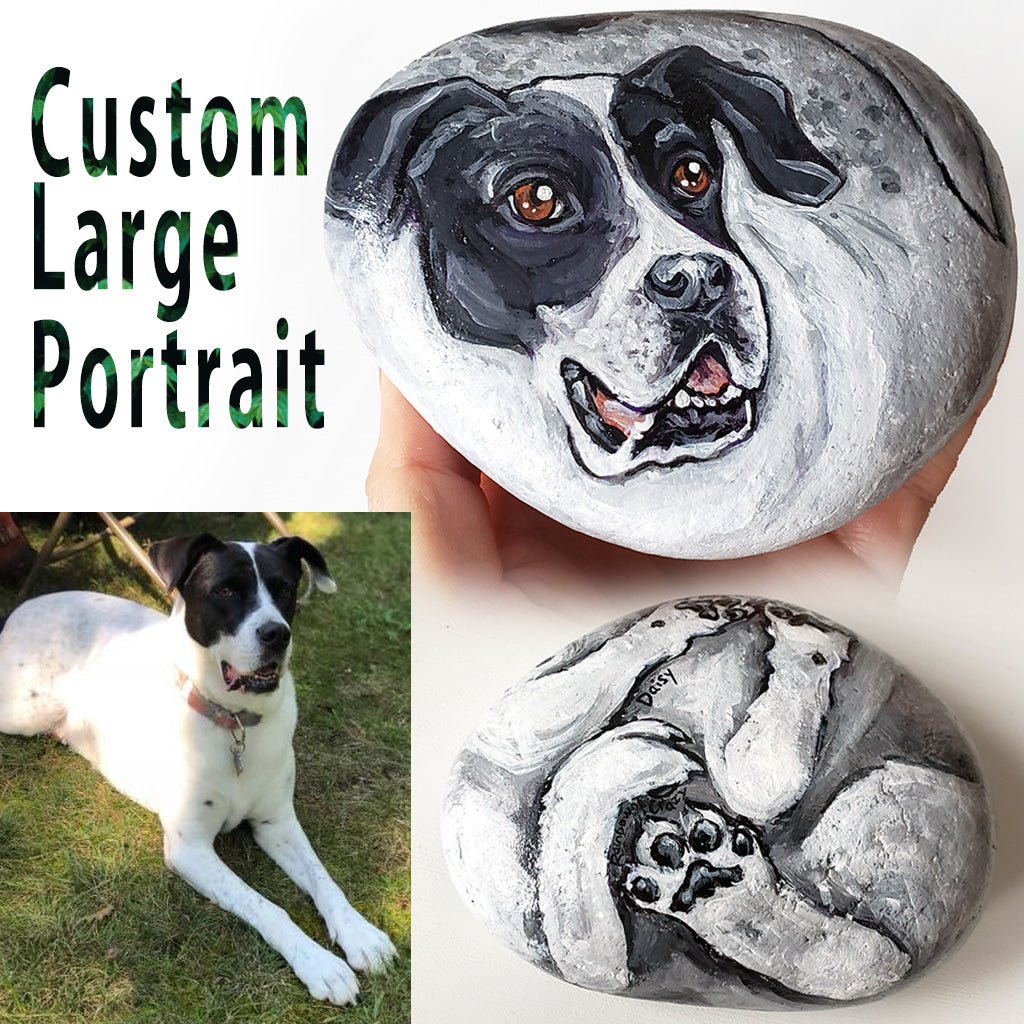A custom pet portrait painting, on a large stone, of a black and white dog,