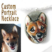 Load image into Gallery viewer, A personalized pet portrait, painted on a small beach stone, of a Shiba Inu dog smiling
