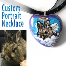 Load image into Gallery viewer, A customized pet portrait necklace, painted on a heart shaped beach stone, of a little brown lionhead rabbit painted as an angel.
