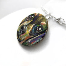 Load image into Gallery viewer, A round wood pendant necklace is hand painted with a portrait of a dacshund dog
