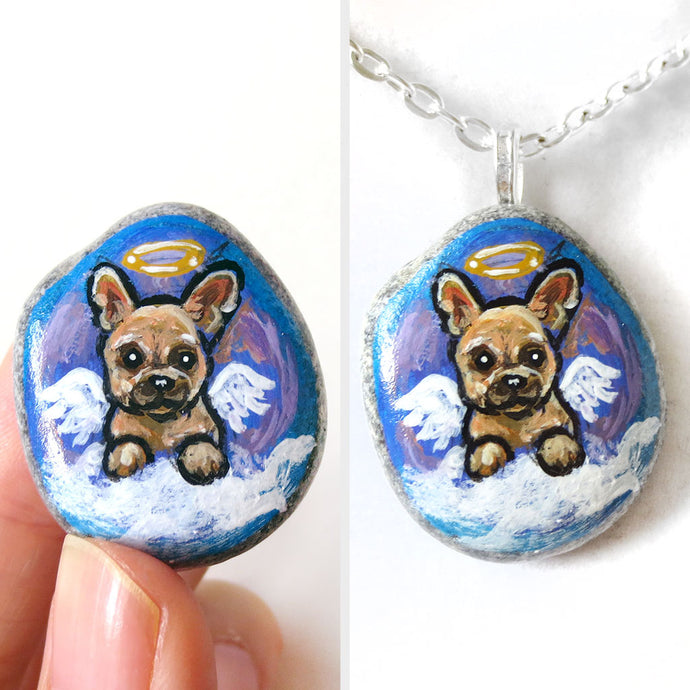 a small beach stone painted with dog art: a french bulldog as an angel in the clouds. available as a stone keepsake or a pendant necklace
