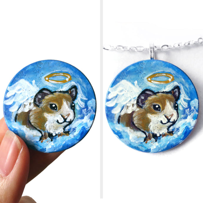 a wood circle disc, with pet art: a painting of a brown and white guinea pig as an angel, on clouds in a blue sky. available as a keepsake or pendant necklace
