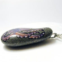 Load image into Gallery viewer, the side of a pendant necklace, crafted with a small beach stone and hand painted with an octopus
