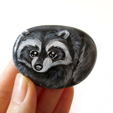 Load image into Gallery viewer, A small beach rock painted with raccoon art
